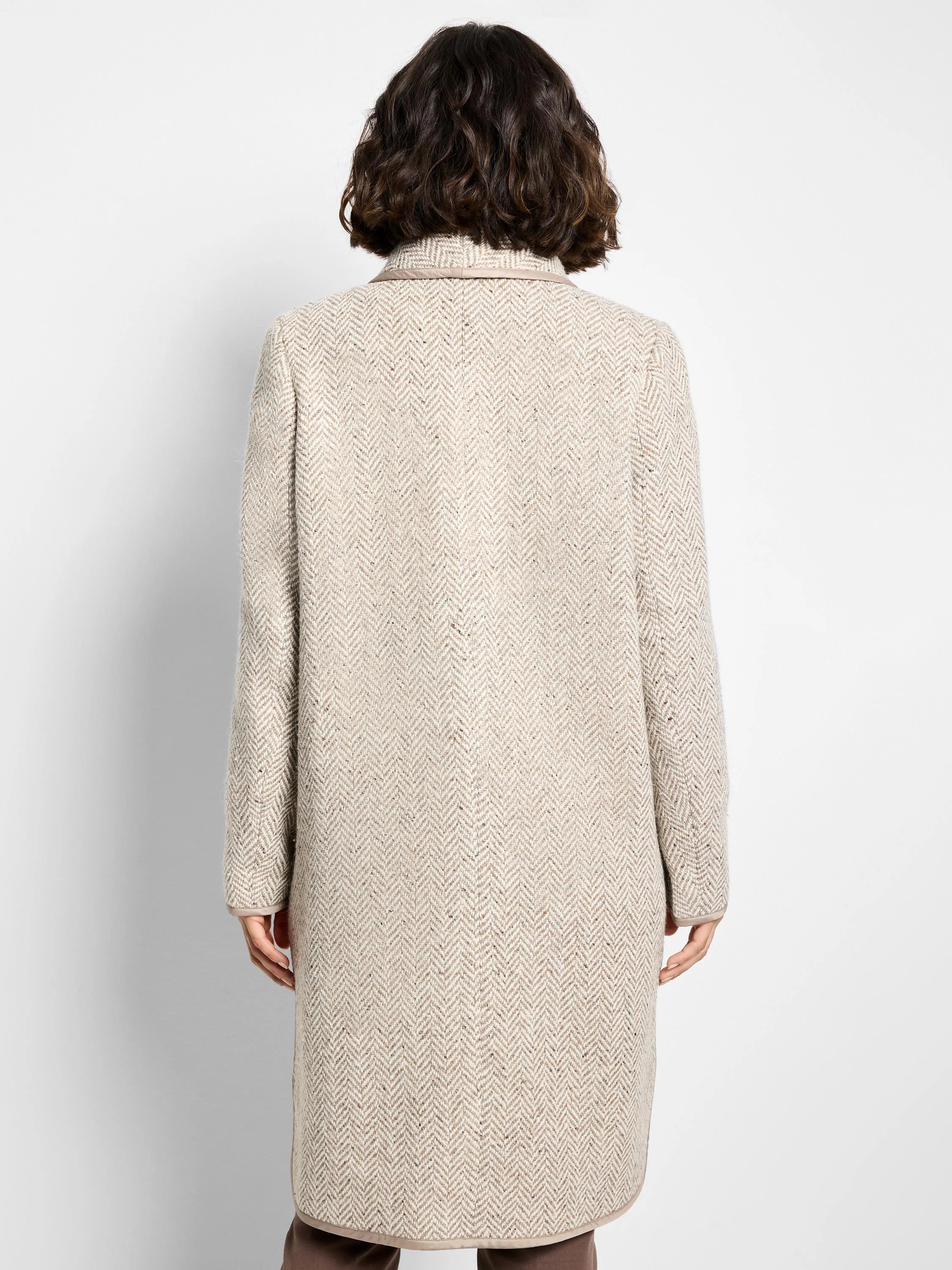 Beige wool topcoat with herringbone pattern.  Features a lighter beige trim. Shown from the back.