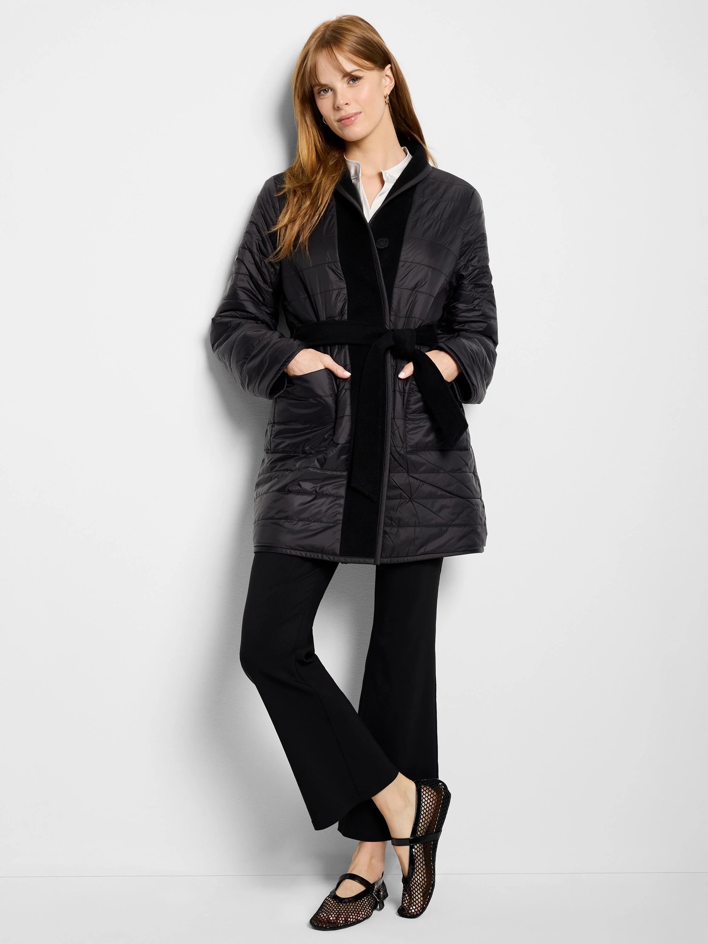 Black quilted wool top coat with a black self-belt.  Features a contrasting black panel down the center.