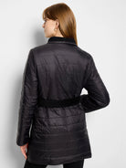 Black quilted coat, belted, long sleeves.  Reverse side not shown.