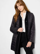 Black quilted wool topcoat. Reversible. One side is shiny, the other is matte.  Features dark buttons.
