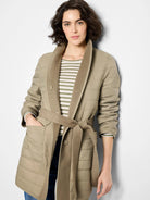 Beige quilted coat with a wool lining, belted waist, and single button closure.  Reversible to show a solid beige wool side.