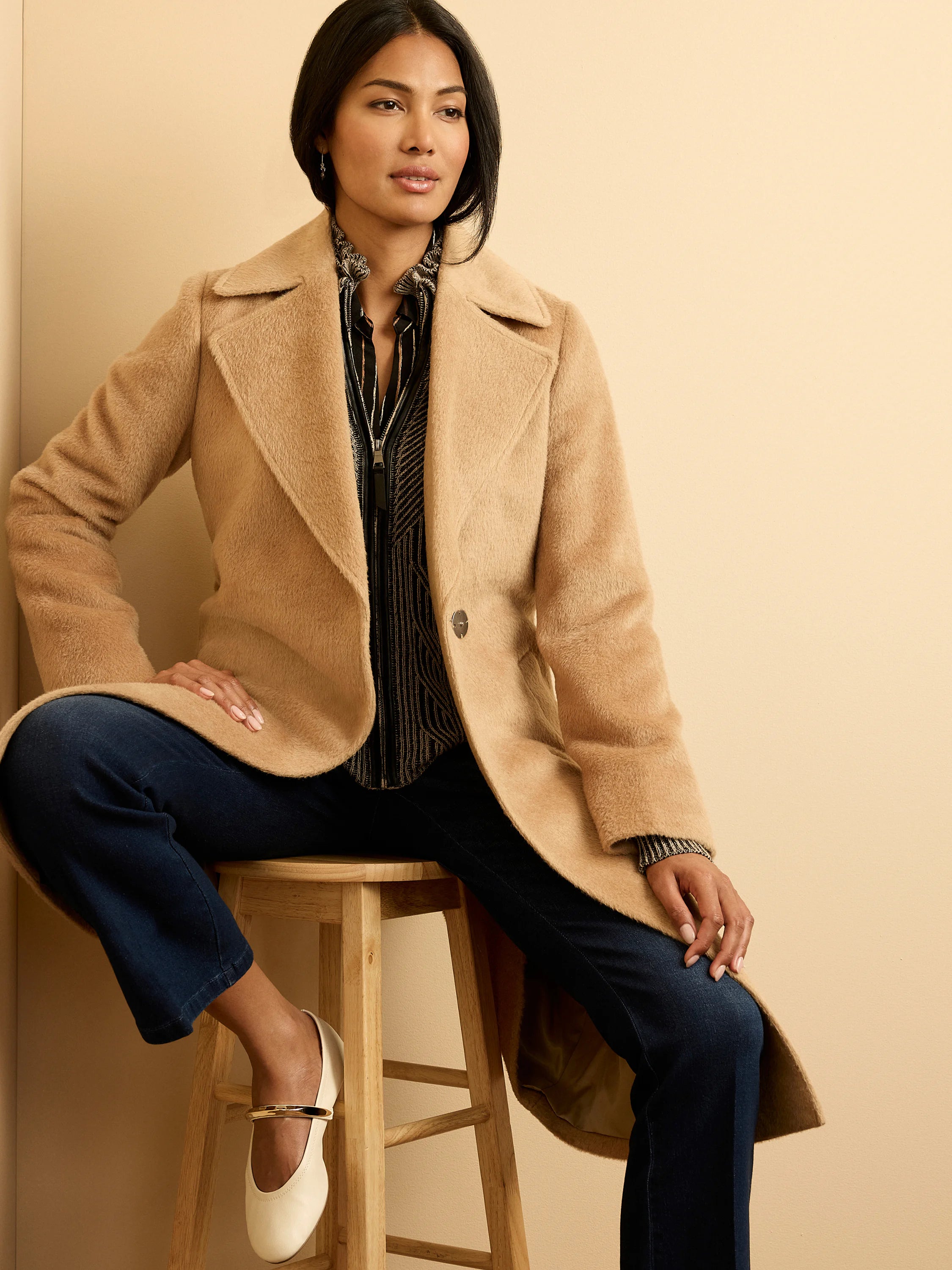 Camel-colored wrap coat with a soft, fuzzy texture, wide lapels, and a single button.