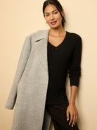 Light gray alpaca blend wrap coat with wide notched lapels and a soft, visibly textured surface.
