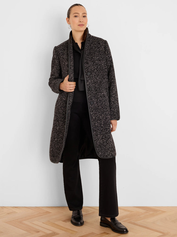 Mid-length dark gray jacquard coat with light flecks, subtle herringbone pattern, black trim on edges, and front buttons.