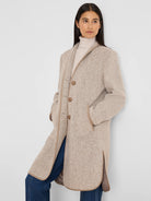 Light beige long coat with a jacquard herringbone pattern, tan piping, buttons, and side pockets.