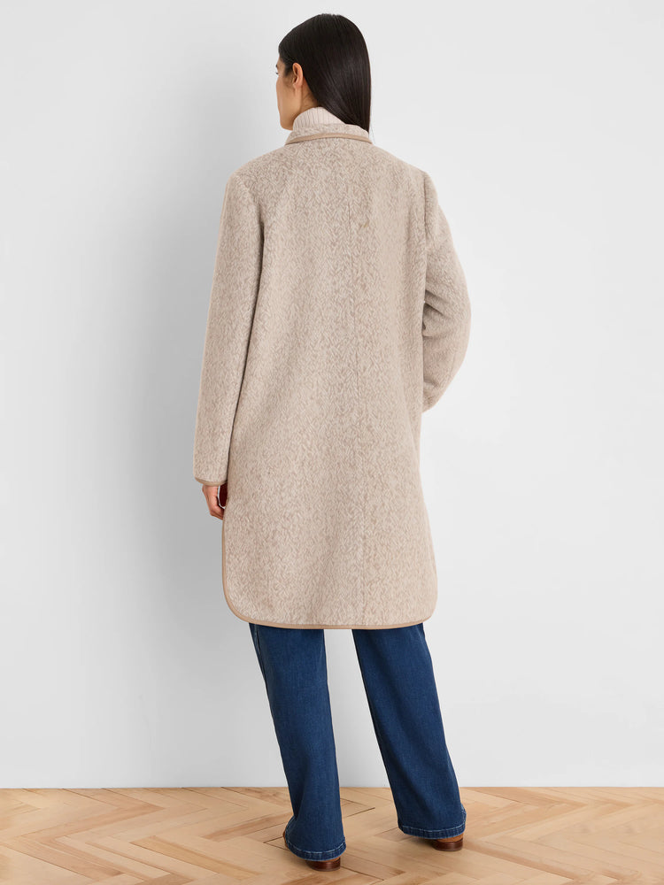 Light beige herringbone jacquard top coat with tan piping at collar and hem.
