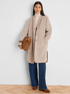 Light beige jacquard top coat featuring a subtle woven pattern, button front, soft lapel, and tan contrast trim.