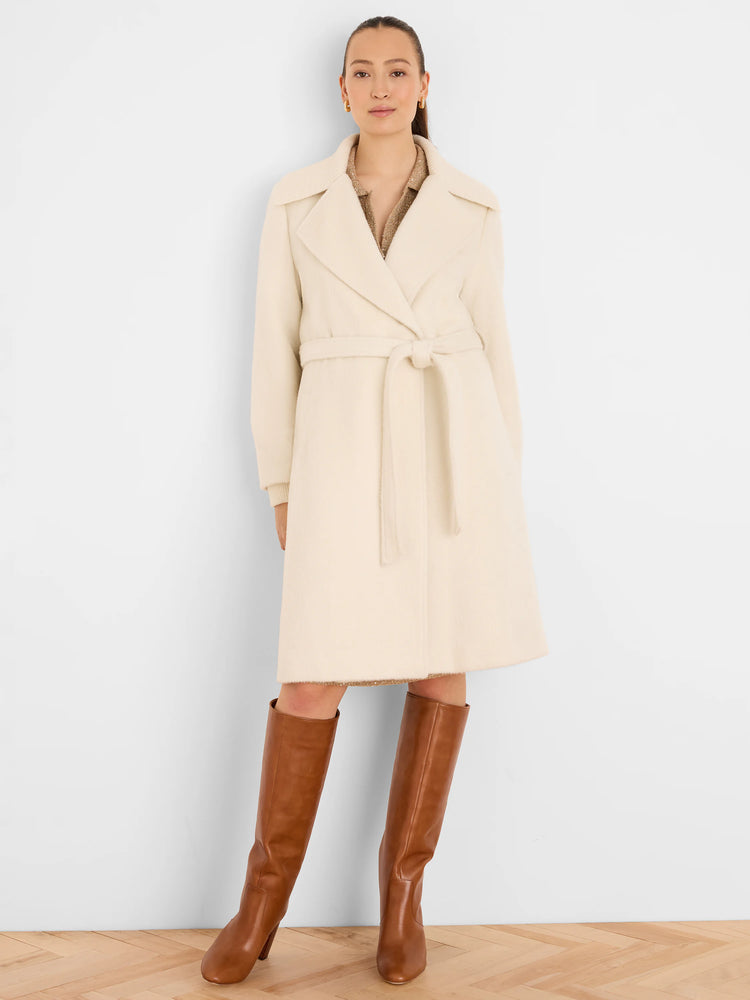 Ivory wrap coat with wide lapels, a self-tie belt, and knee-length hem. Visibly soft, fuzzy texture.