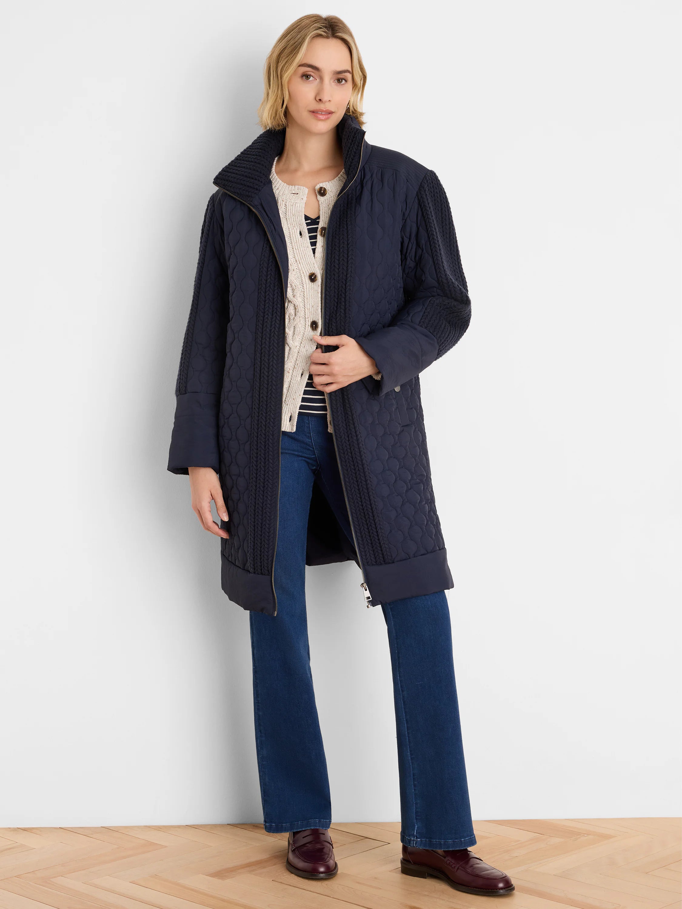 Dark blue mixed media parka. Quilted body, cable knit sleeves & high collar. Mid-thigh length, zippered.