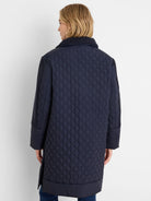 Navy mixed media puffer parka. Oval-quilted body, knit collar and upper sleeves.
