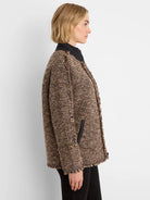 Brown & black textured coat with fringe on edges and cuffs, open front, black collar and pocket trim.
