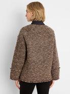 Brown, black, & tan mixed knit coat with a round neck and fringe at cuffs & hem.