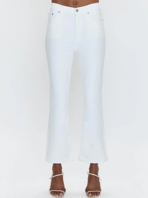 White high-rise crop bootcut jeans with silver button and rivets. Flared legs end above ankles, shown on a model.