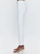 White high-rise crop boot jeans, side view. Fitted through thigh, subtle side seam, cropped above ankle.
