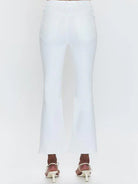 White high-rise crop bootcut jeans, back view. Visible back pockets. Legs flare slightly, cropped above ankle.