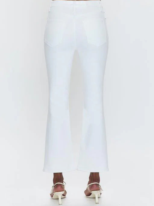 White high-rise crop bootcut jeans, back view. Visible back pockets. Legs flare slightly, cropped above ankle.