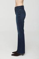 Dark blue denim high-rise bootcut jeans. Side view shows front & back pockets.
