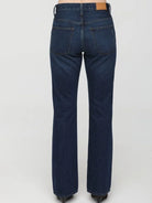 Dark blue high-rise bootcut jeans, shown from the back. Features two back pockets and a tan brand patch on the waistband.