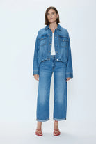 Medium blue denim blouson jacket with a gathered hem, button front, and two chest pockets.