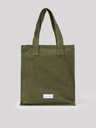 Olive green cotton tote bag with two fabric handles. Small white 'LES PENSIONNAIRES' label on the front.