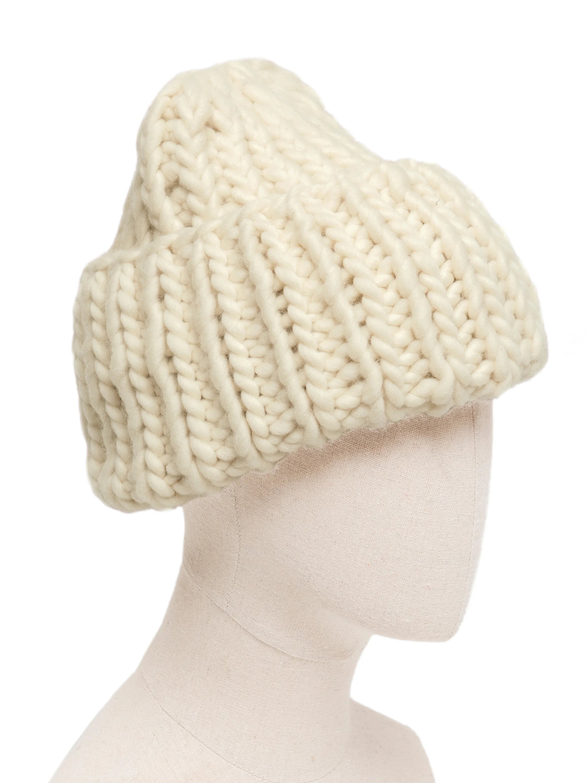 Cream-colored, chunky roving knit hat with prominent, thick stitches, displayed on a mannequin head.