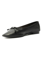 Black leather ballet flat with a pointed toe, a small tied bow on top, and a low heel.