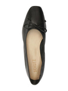 Black Schutz Arissa flat shoe with a square toe, small bow, and tan interior sole, viewed from above.