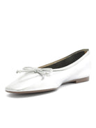 Metallic silver ballet flats feature a subtle square toe shape and a matching bow detail on the vamp.