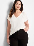 Off-white v-neck short-sleeve top.