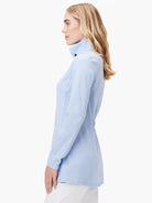 Light blue, long-sleeve knit jacket. Mock turtleneck, subtle vertical ribbing.  Close-fitting.