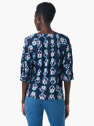 Dark navy top with teal, pink & beige batik pattern. Three-quarter sleeves, V-neck.  Back view shown.