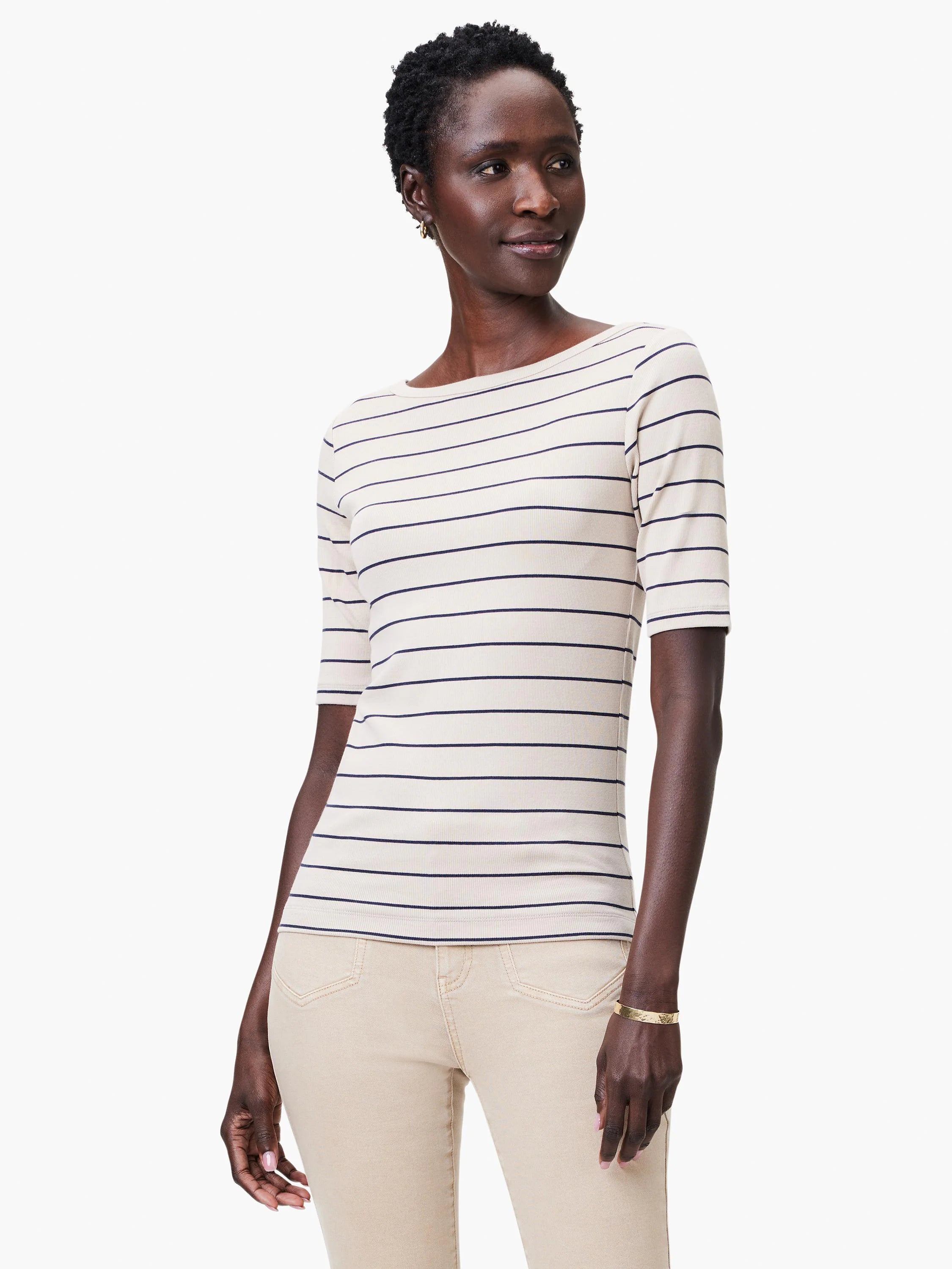 Off-white boatneck top with thin navy stripes, three-quarter sleeves, ribbed knit texture.