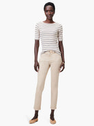 Off-white boatneck tee with thin, dark stripes; short sleeves.