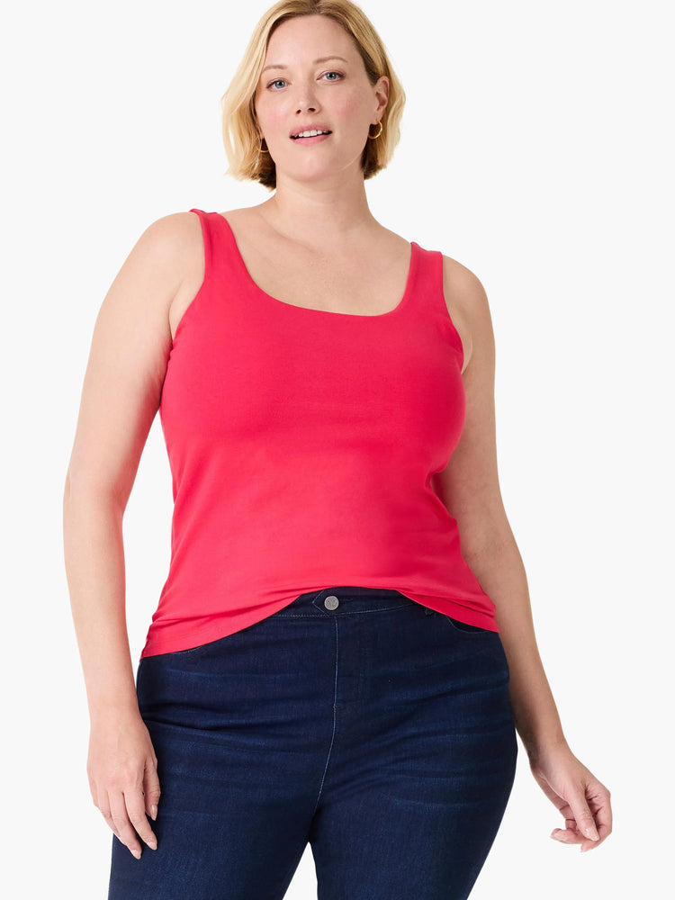Woman wears a pinkish-red tank top with wide straps and a square neckline.