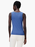 Model's back in a blue ribbed knit tank with a scoop neck and fitted body.