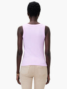 Light purple ribbed knit scoop tank, back view, worn by model. Paired with tan pants.