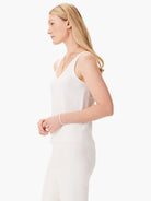 Here's alt text for the image, under 125 characters:

White knit sleeveless top, V-neck.  Shown on model.