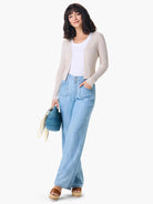 Beige ribbed cardigan, button front.  Model also wears light blue jeans.