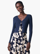 Navy blue ribbed cardigan, cropped length, long sleeves, V-neck.  Small dark metal button closure.