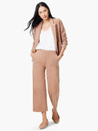 Beige textured knit jacket, shown on a model.  The jacket is open, revealing a white top underneath. The model also wears...