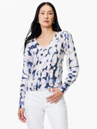 Beige sweater with blue,  off-white, and  gold abstract print. V-neck, long sleeves.