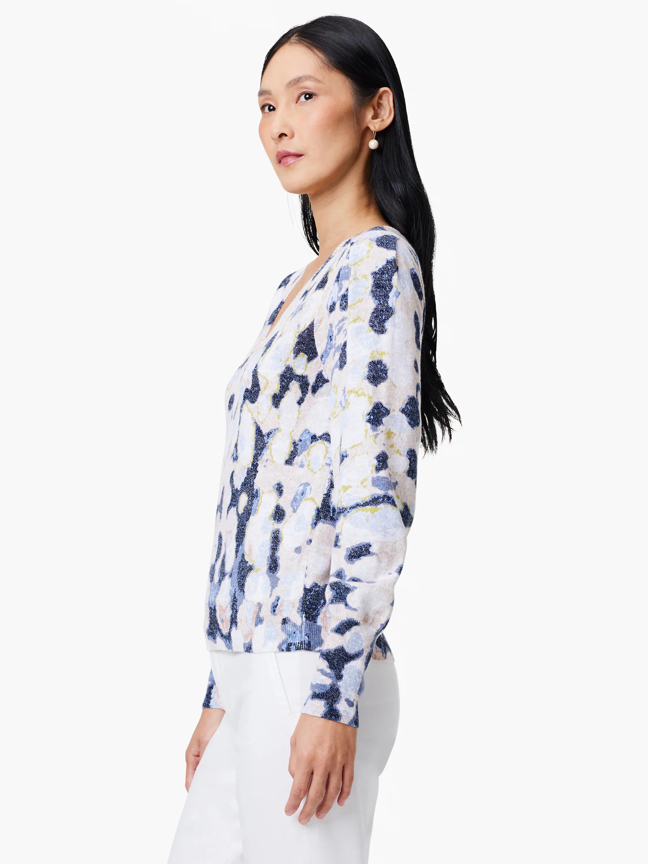 White cardigan with blue, beige, and green abstract print.  Long sleeves, V-neck.