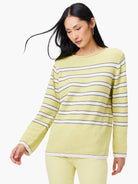 Pale yellow sweater with horizontal white and navy stripes; long sleeves, and a slightly loose fit.