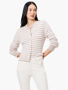 Beige cardigan with white stripes, long sleeves, and button closure.