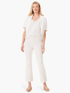 Off-white short-sleeved open-front cardigan.  Textured knit fabric. Model shown wearing with off-white pants and light...