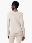 Oatmeal cotton cord sweater, back view. Fine ribbed knit, long sleeves, and a gentle scoop neck.