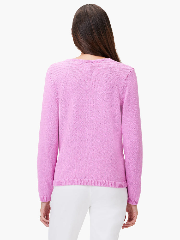 Back of a woman in a lilac long-sleeved knit sweater with ribbed cuffs and hem.