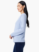 Light blue knitted V-neck sweater with long sleeves, ribbed cuffs and hem.