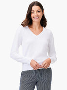 White slub v-neck sweater, long sleeves.  Slightly textured fabric.