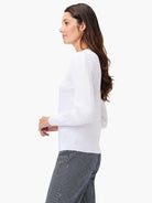 White slub knit V-neck sweater, long sleeves, shown on a model.